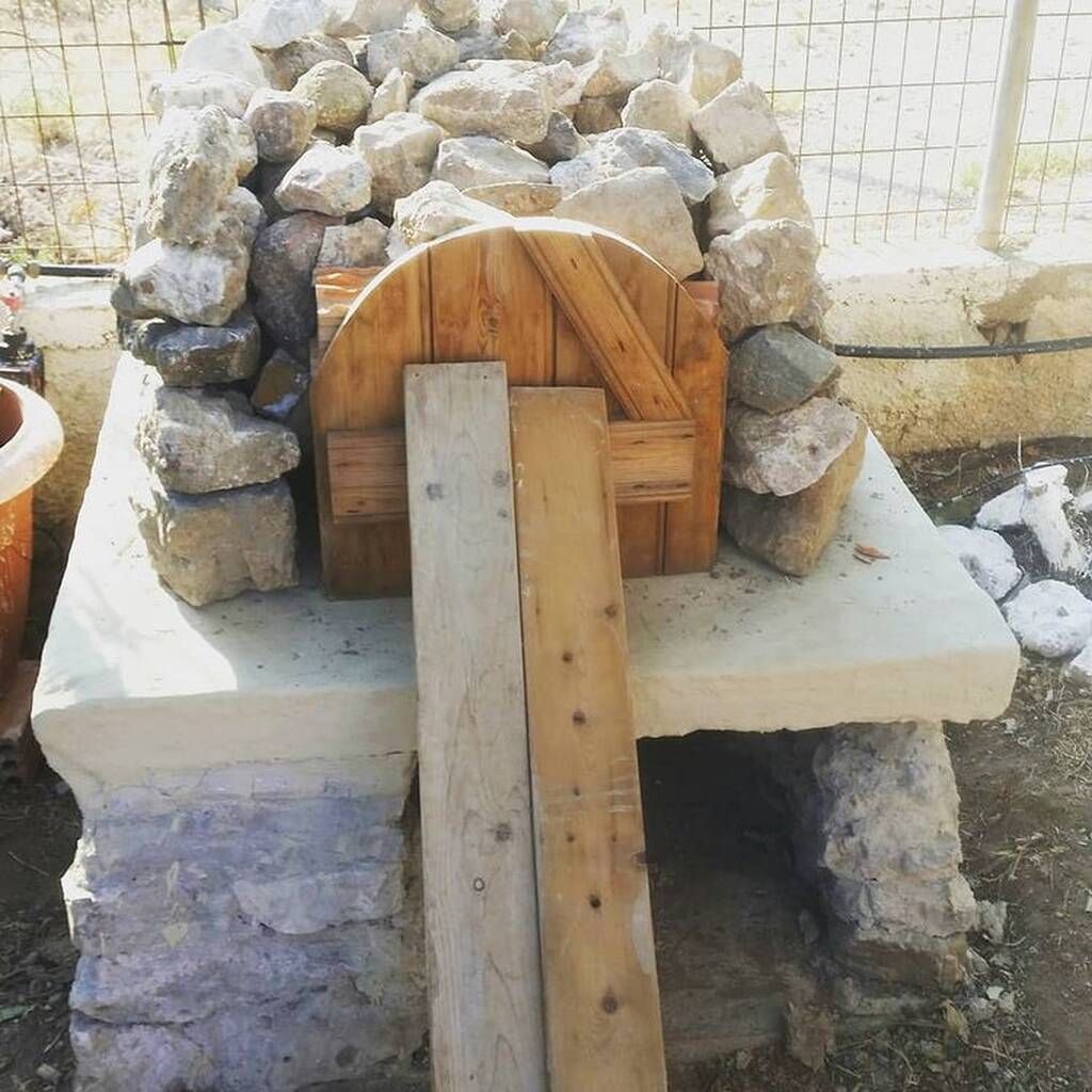Ο Λεωνίδας Μπαλάφας, η κόρη του Δωροθέα και ο γιος του έφτιαξαν έναν παραδοσιακό ξυλόφουρνο με χώμα, πέτρες και ξύλο.