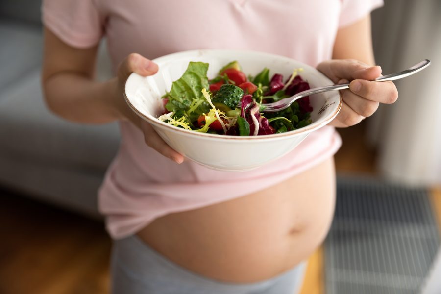 Expectant Mother Holding Bowl With Fresh Vegetable Salad