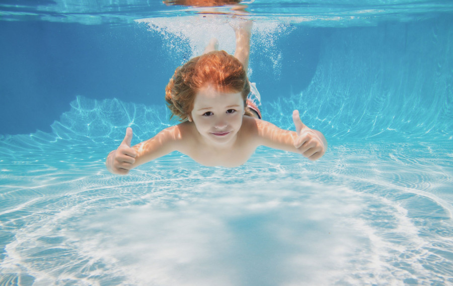 Child Swimming Underwater With Thumbs Up. Underwater Kid Swim Under Water. Child Boy Swimming And Di