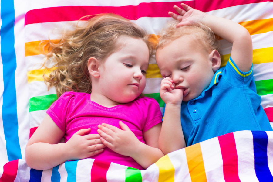 Children Sleeping Under Colorful Blanket